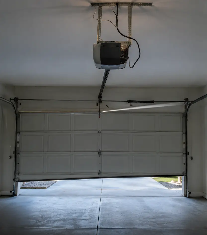 Damaged residential garage door before professional repair in Whitestown